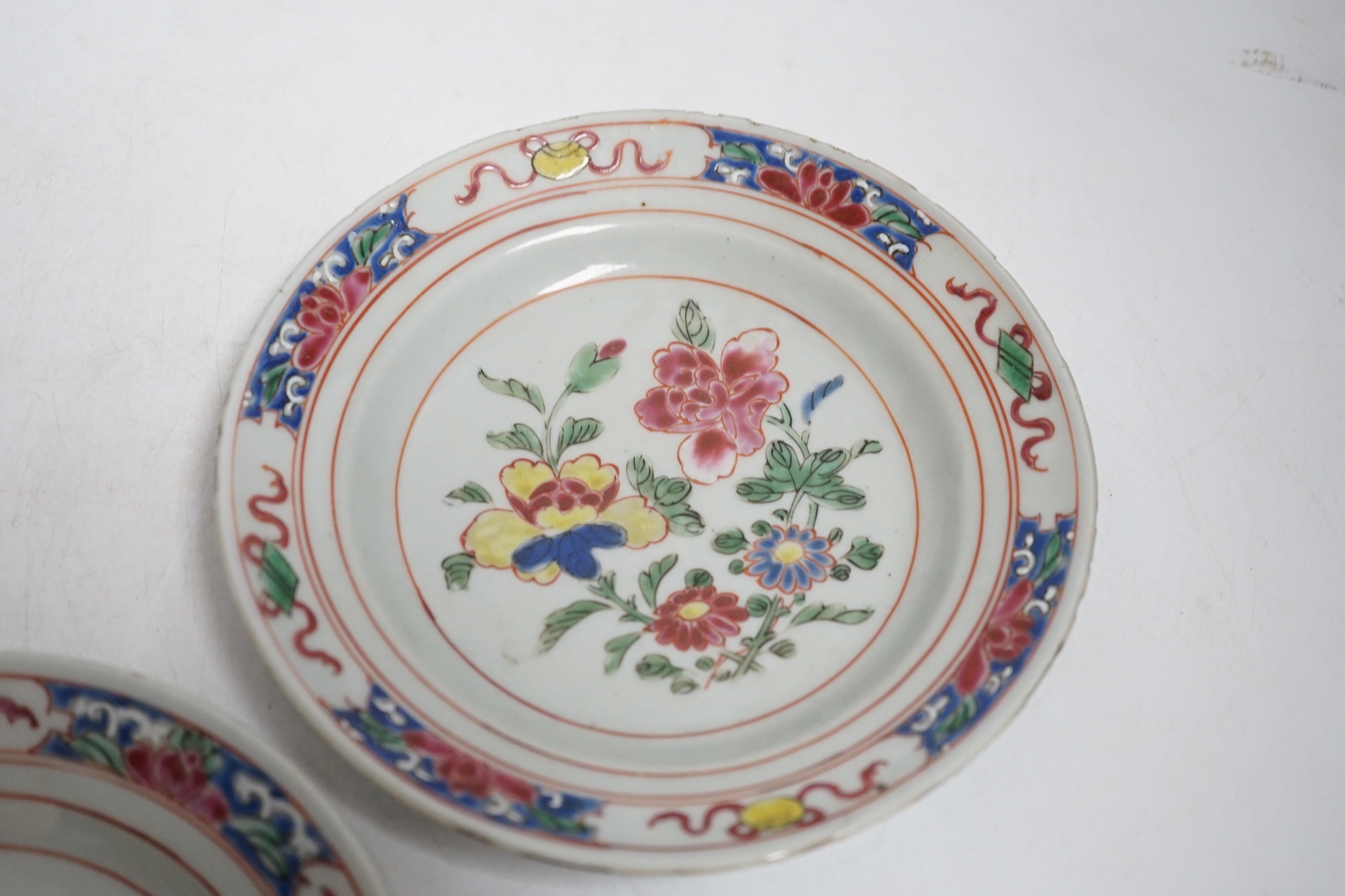 A pair of Chinese famille rose fencai small plates, early Yongzheng period, 16 cms diameter